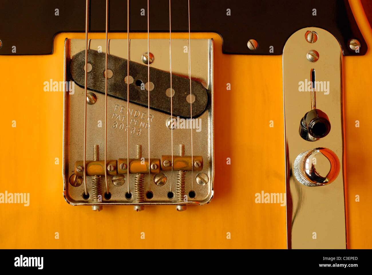 Fender Telecaster electric guitar. 1952 Re-issue. Detail of bridge and pickup assembly and control plate. Stock Photo