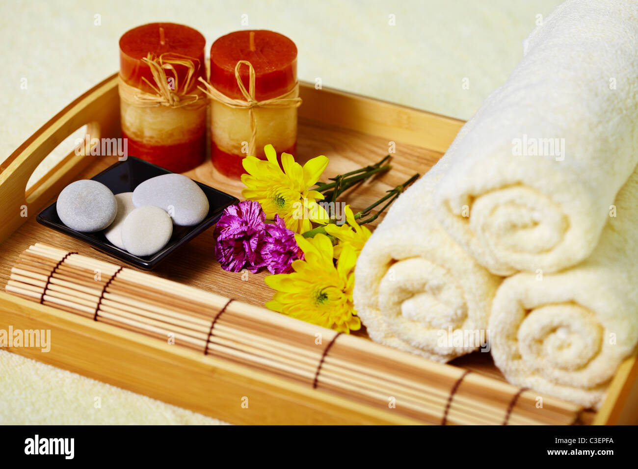 Still life on the spa. A tray of towels, candles and pebbles Stock Photo