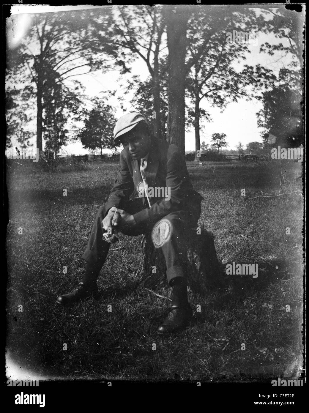 well dressed man in suit sitting on stump fashion male 1890s Stock Photo