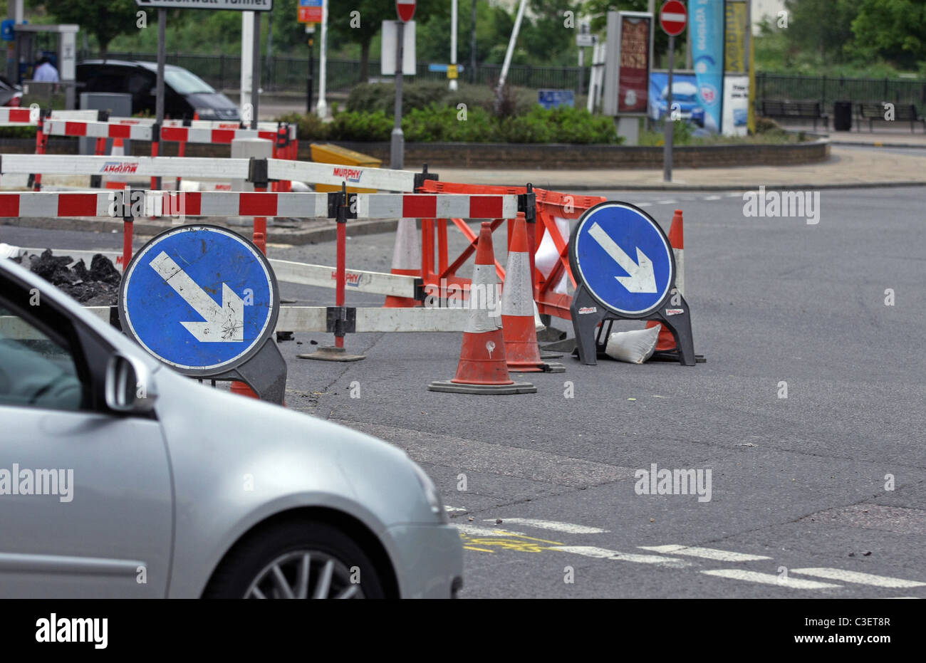 Vehicle passing direction signs, safety barriers and cones around