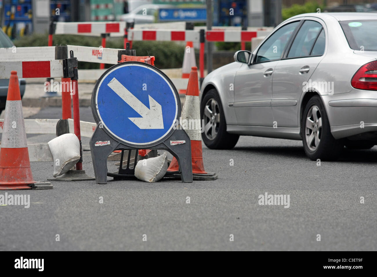 Vehicle passing direction signs, safety barriers and cones around