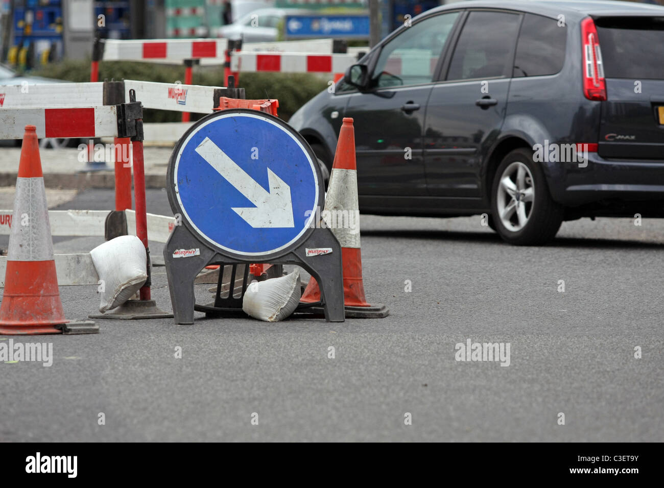 Vehicle passing direction signs, safety barriers and cones around