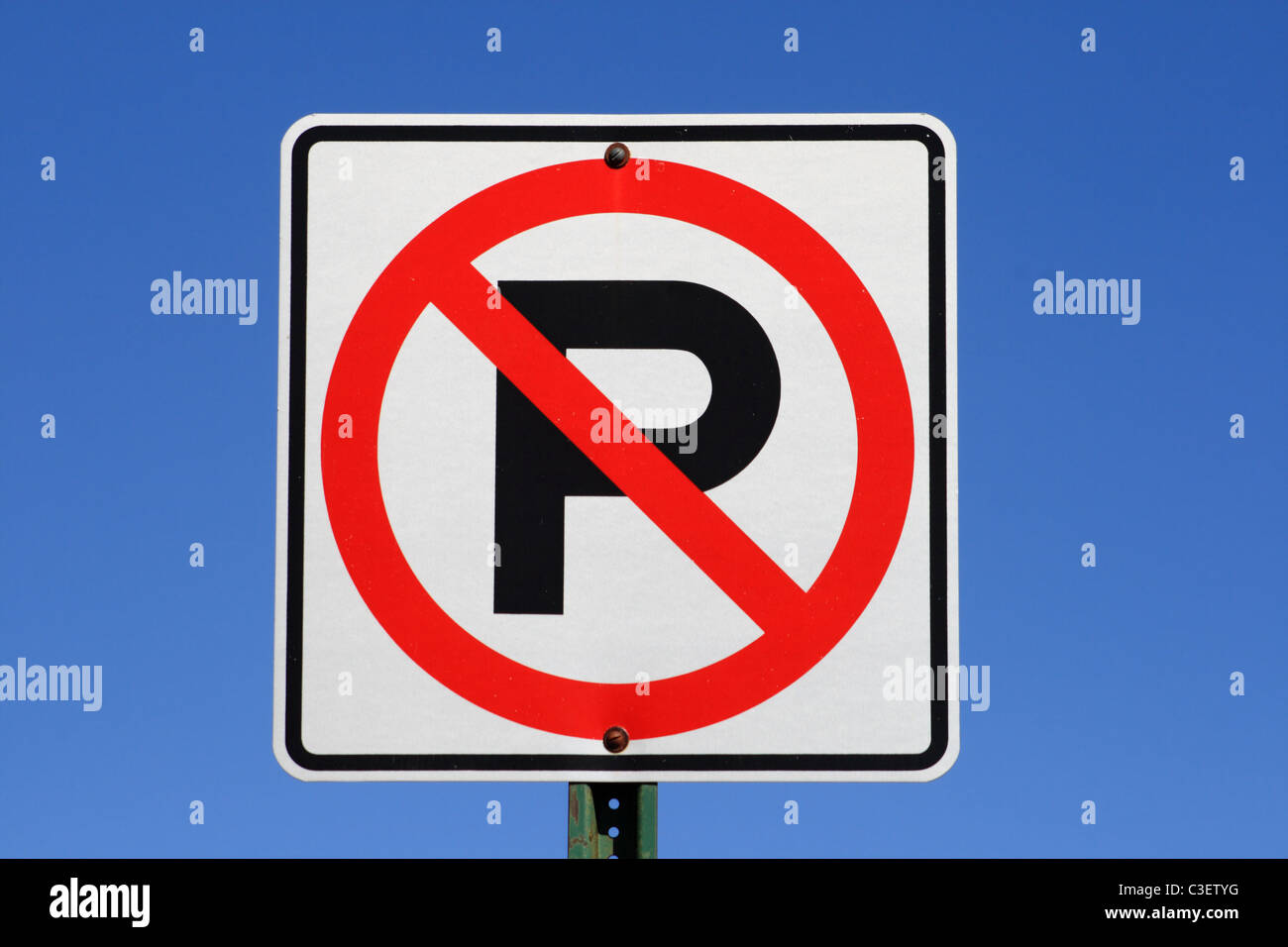 white red and black no parking sign with blue sky background Stock Photo