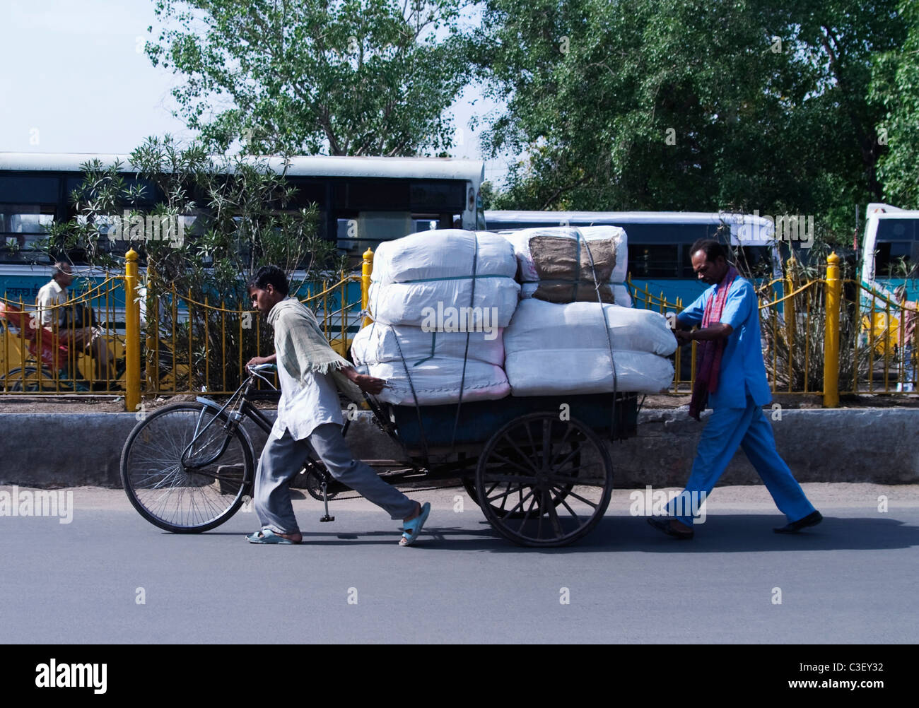 Man pulling an overloaded rickshaw, New Delhi, India Stock Photo - Alamy