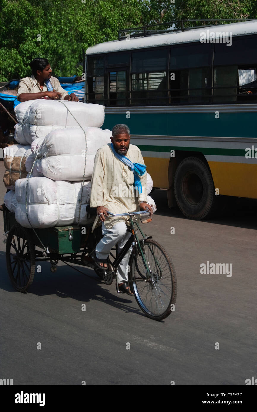 Man pulling an overloaded rickshaw, New Delhi, India Stock Photo