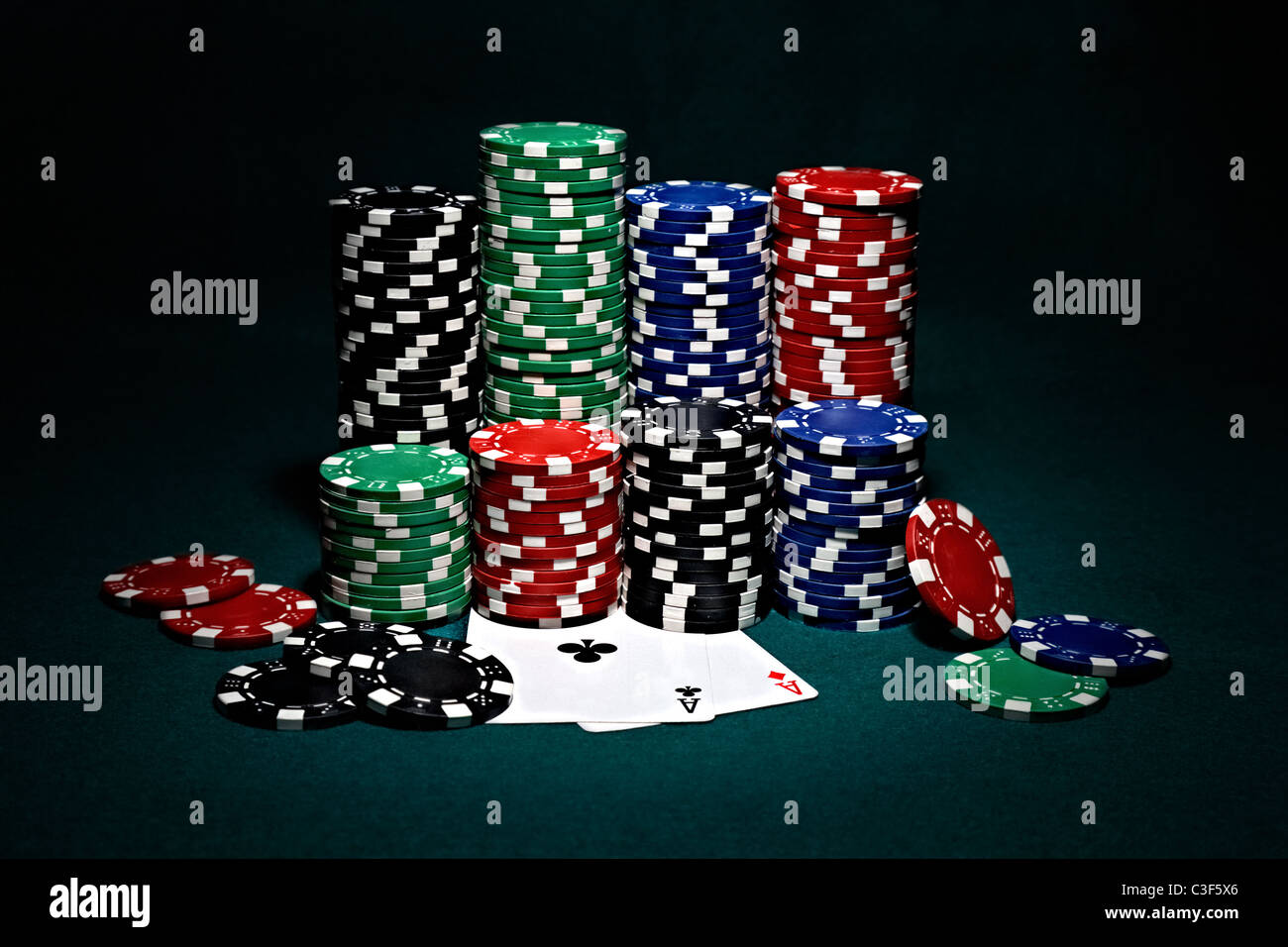 stacks-of-chips-for-poker-with-pair-of-aces-C3F5X6.jpg