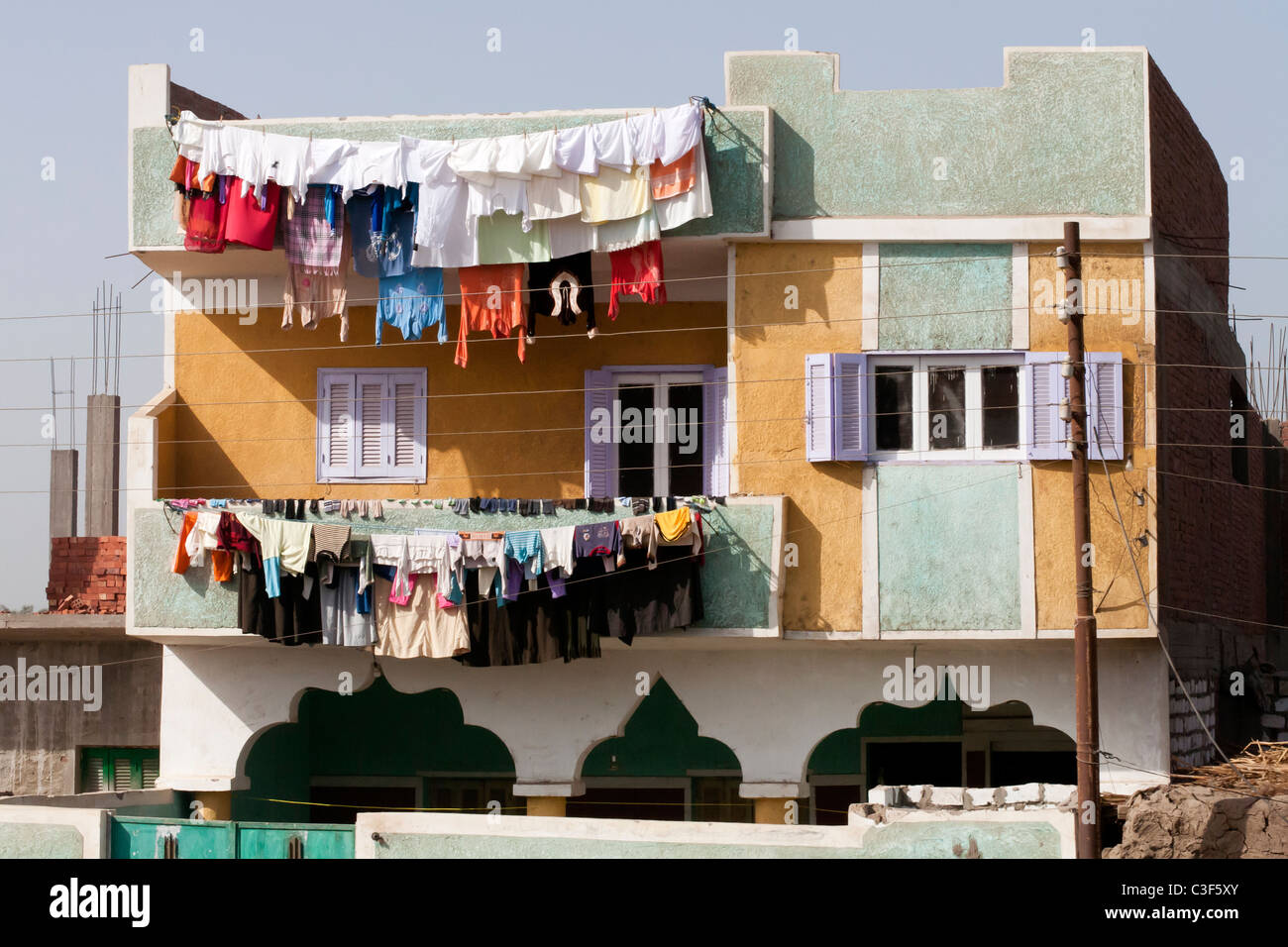 Multi coloured traditional Egyptian house with multi coloured washing hanging from balconies, Egypt, Africa Stock Photo