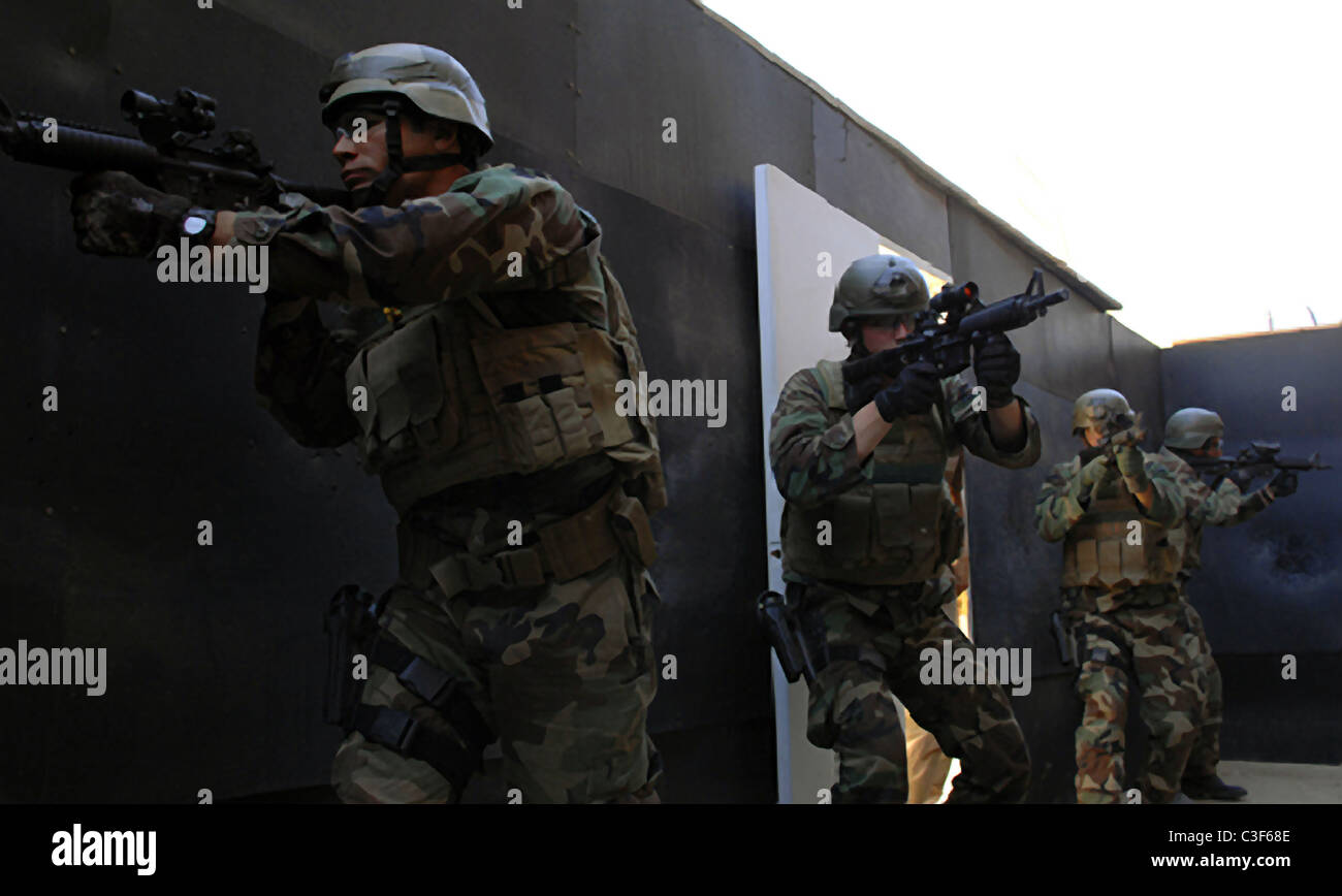 US Navy SEAL trainees prepare to breach a room during a SEAL qualification training exercise. Stock Photo
