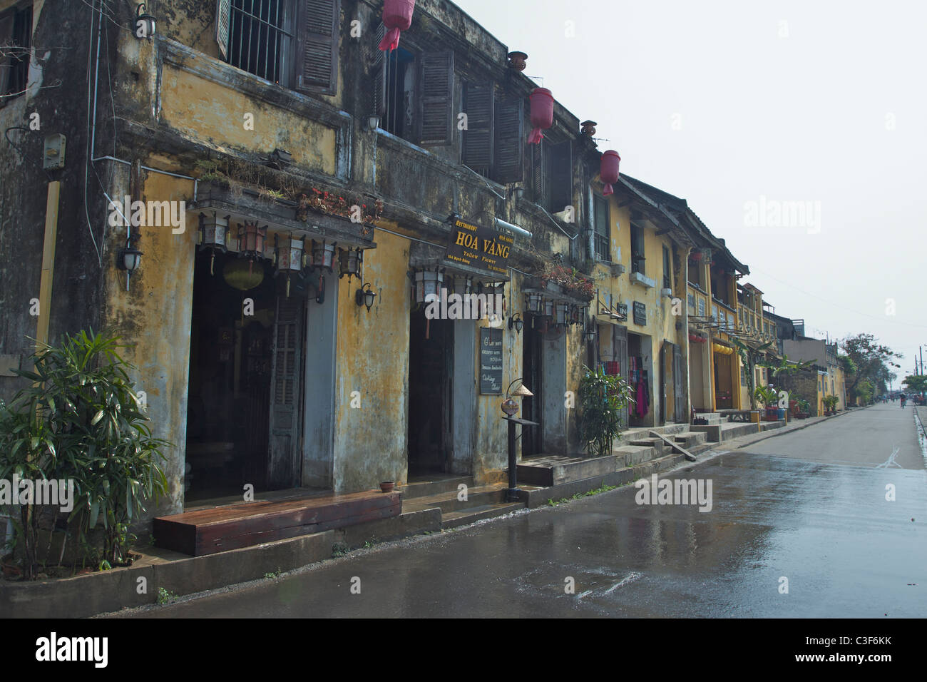 Deserted street in Hoi An, Vietnam. The street has recently been washed. Stock Photo