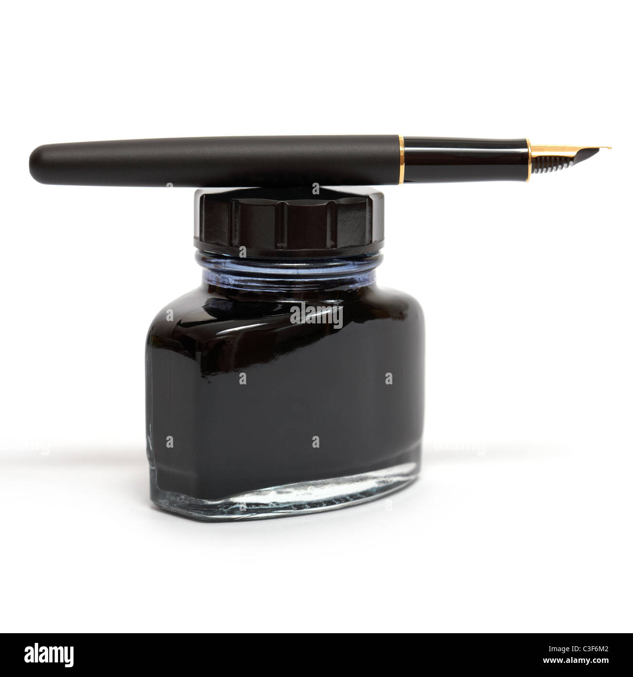 fountain pen lying on the ink bottle Stock Photo Alamy