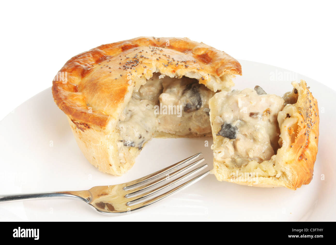 Chicken and mushroom pie on a plate with a fork Stock Photo