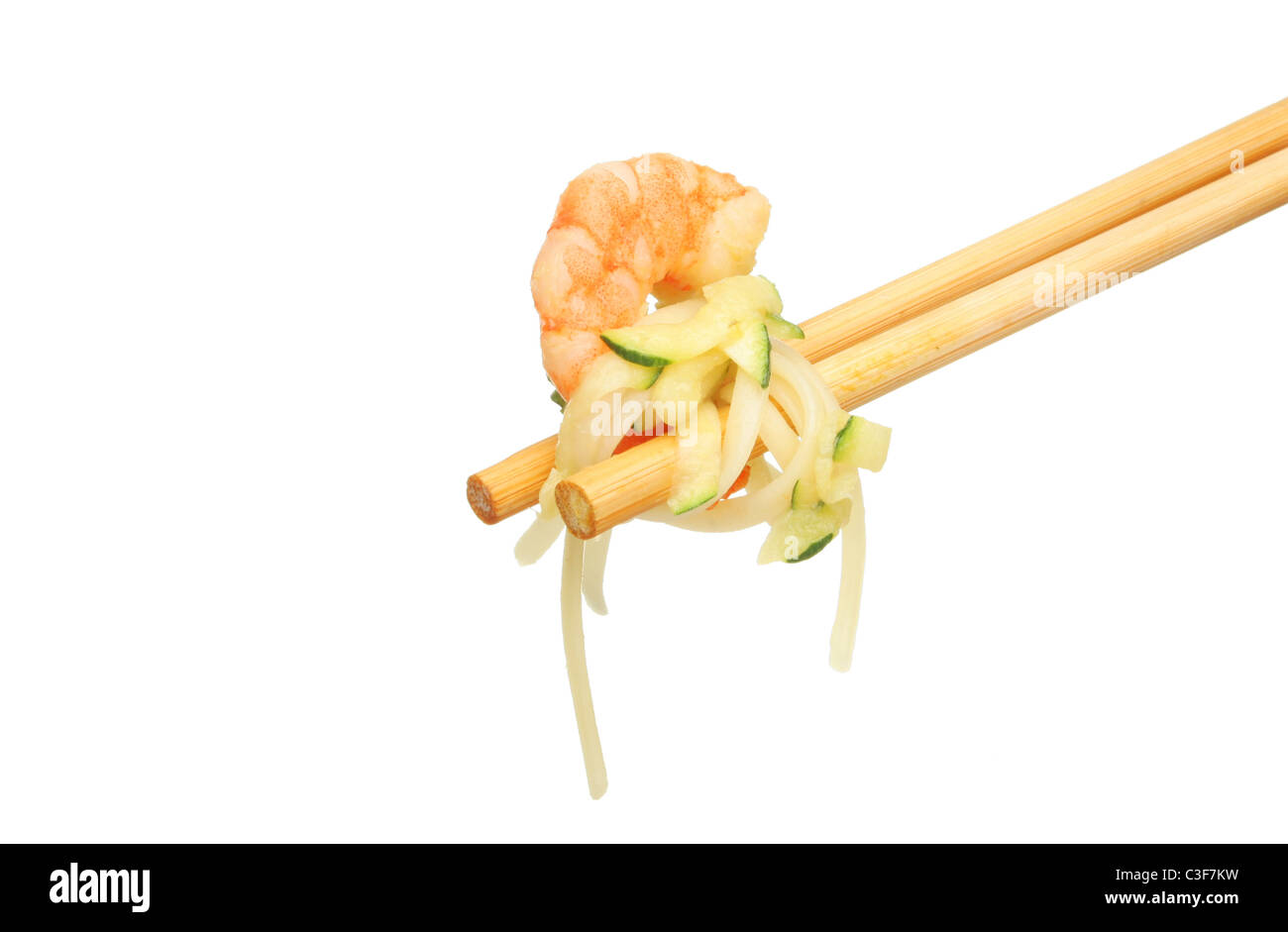 King prawn with vegetables and noodles in chopsticks isolated against white Stock Photo