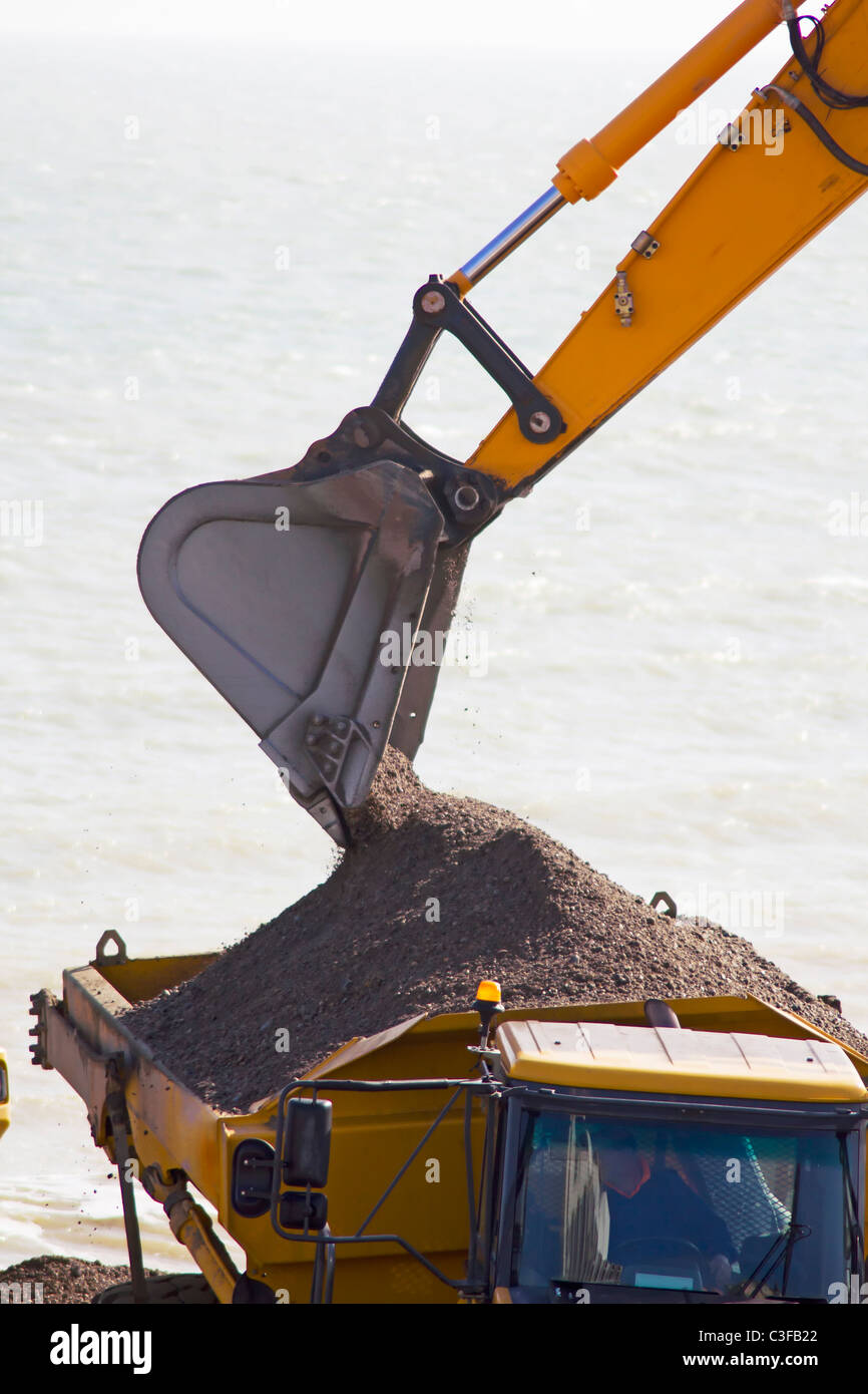 Digger loader a truck full of stones Stock Photo