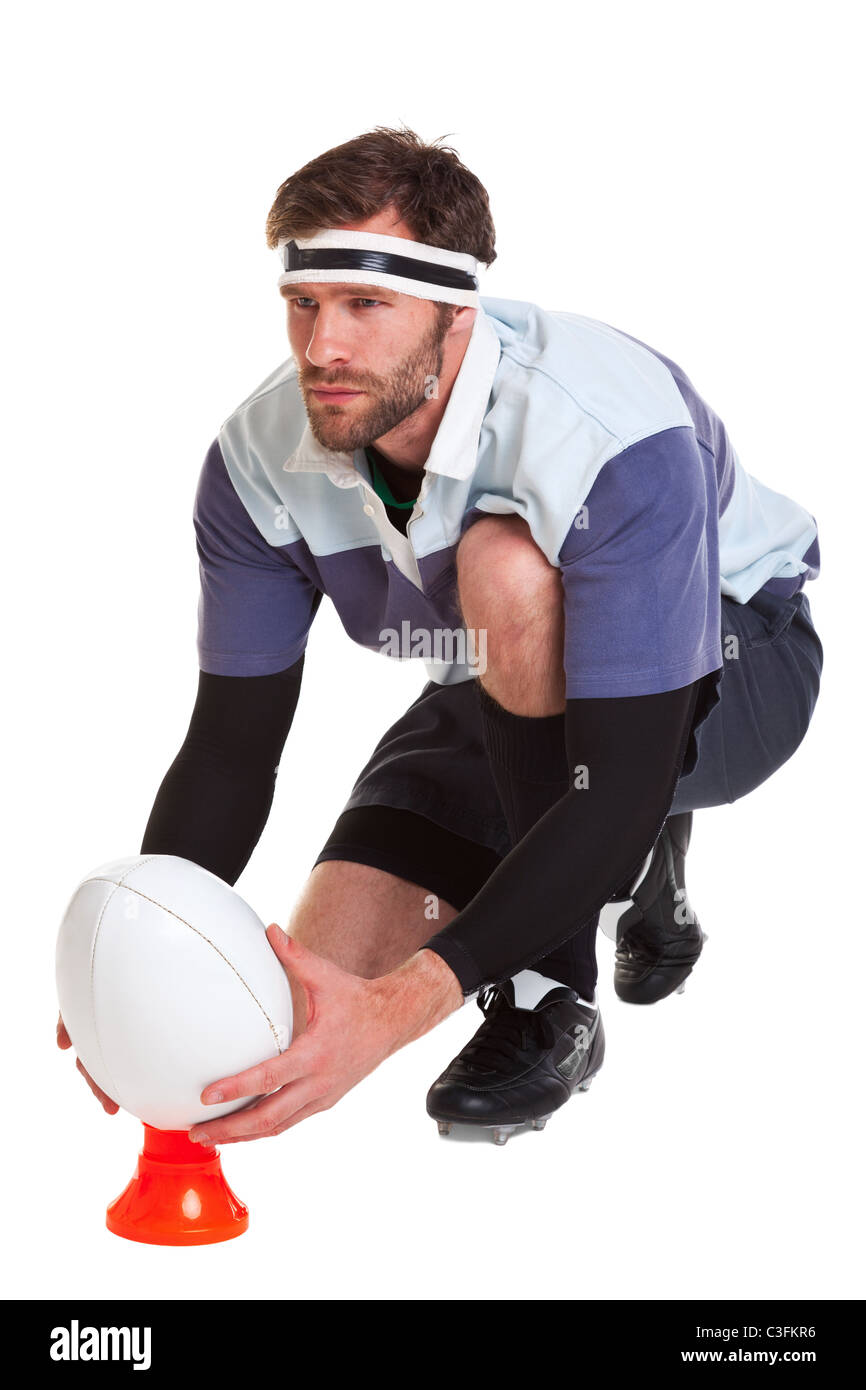 Photo of a rugby player placing the ball on a kicking tee, cut out on a