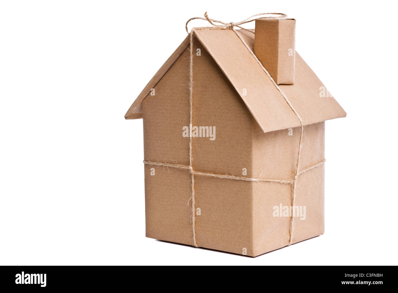 Photo of a wrapped house in brown recycled paper, cut out on a white background. Stock Photo
