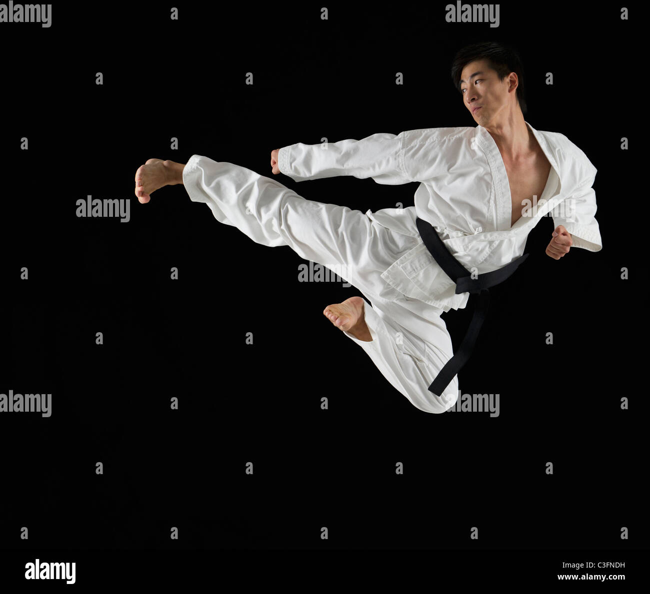 Asian Male Karate Black Belt Kicking In Air Stock Photo Alamy