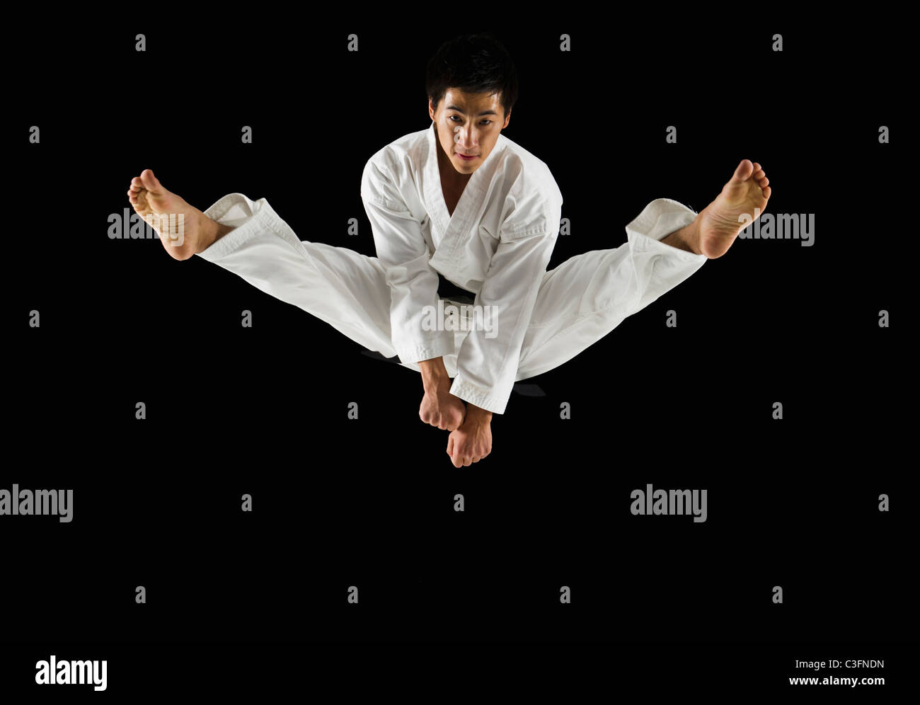 Asian Male Karate Black Belt Kicking In Air Stock Photo Alamy