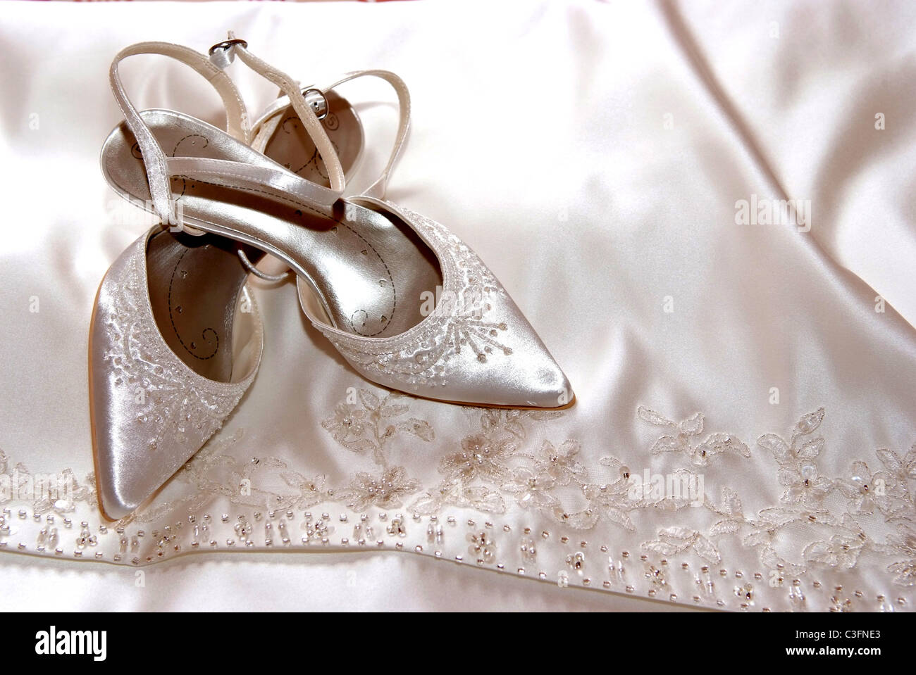 wedding shoes on wedding dress Stock Photo - Alamy