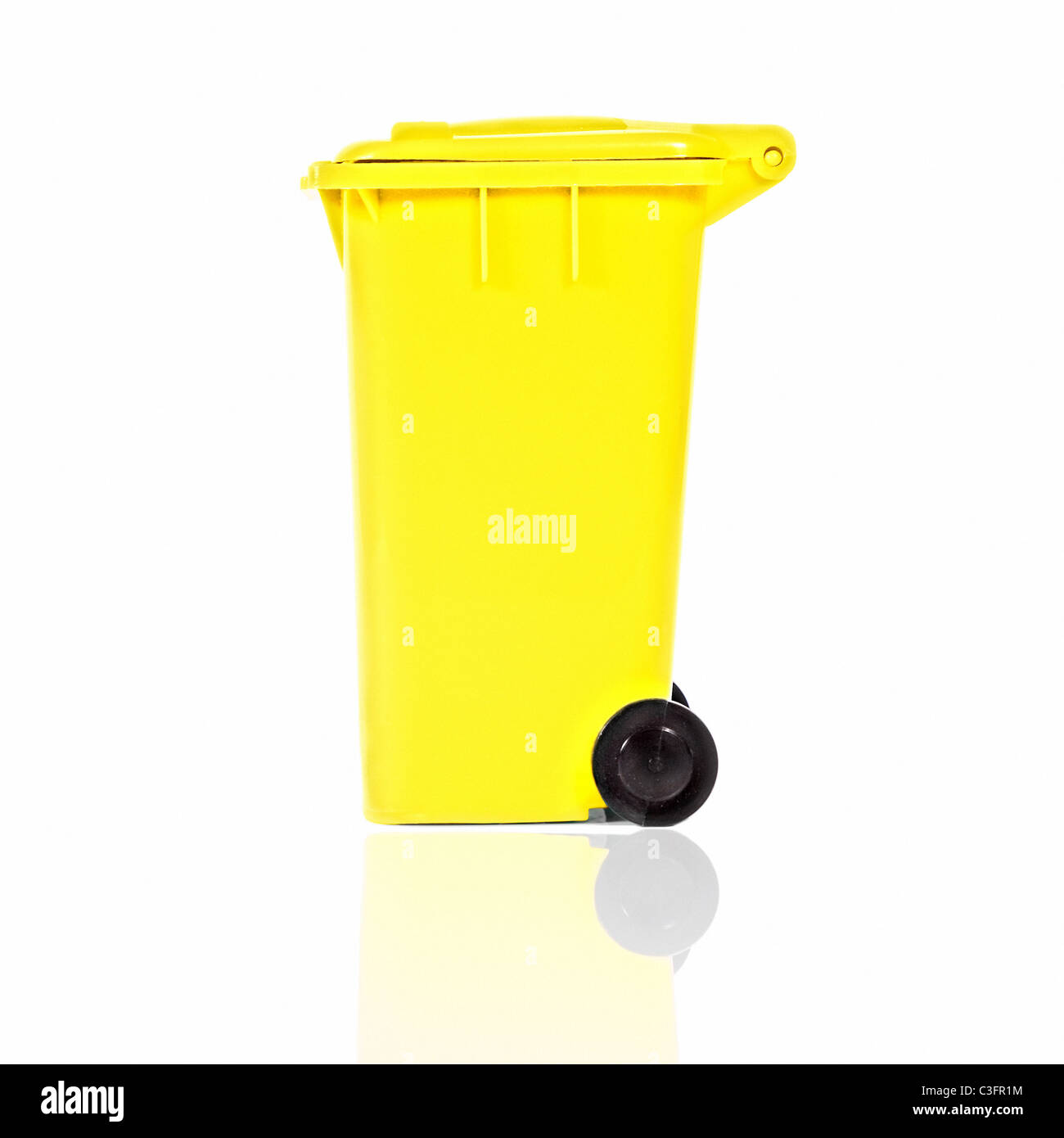 empty yellow recycling bin with reflection Stock Photo - Alamy