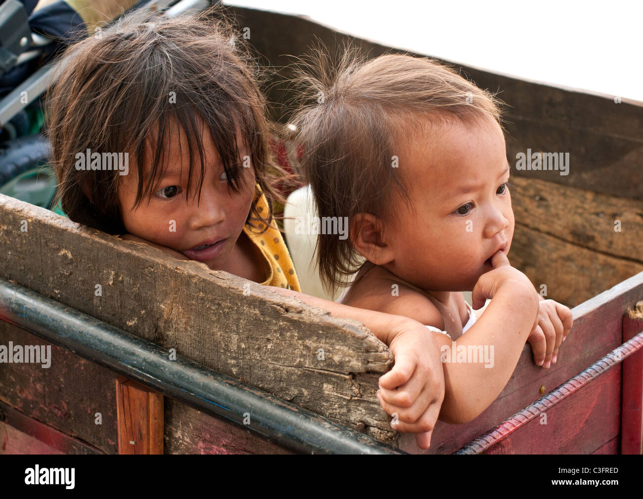 Two young Cambodian girls in a scavengers cart, Siem reap, Cambodia Stock Photo