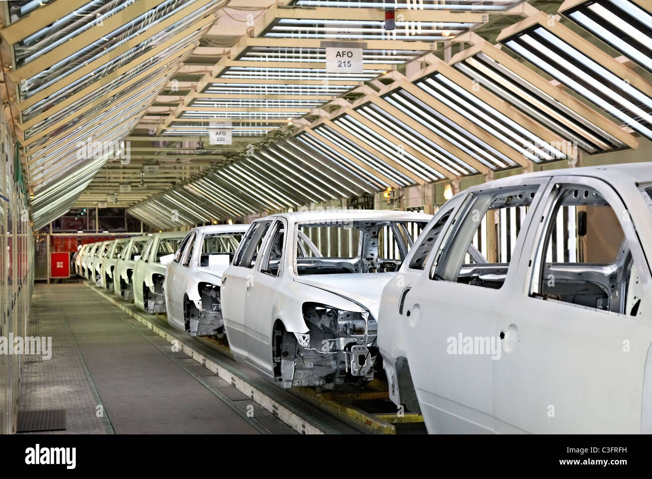 prepared car bodies in a row at car plant Stock Photo