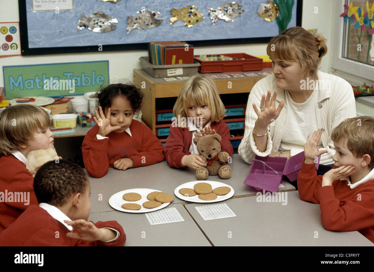 reception class in primary school learning to count with cookies and teddy bears Stock Photo