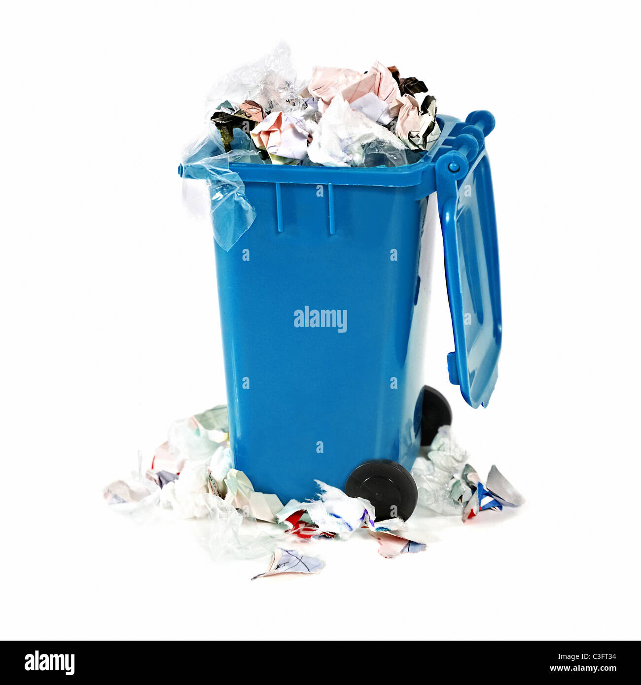 overflowing blue garbage bin on white background Stock Photo