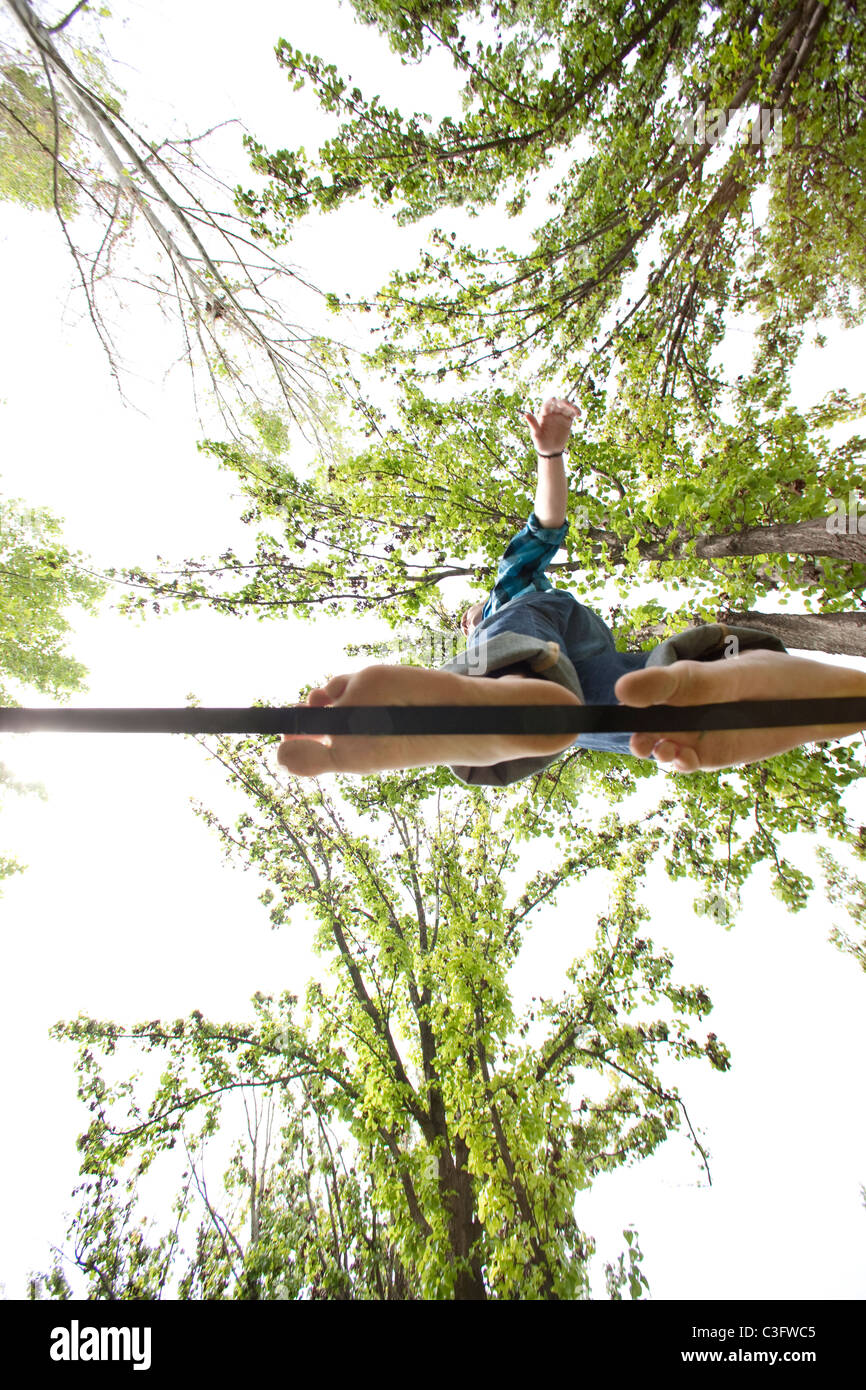 Caucasian man balancing on rope in park Stock Photo