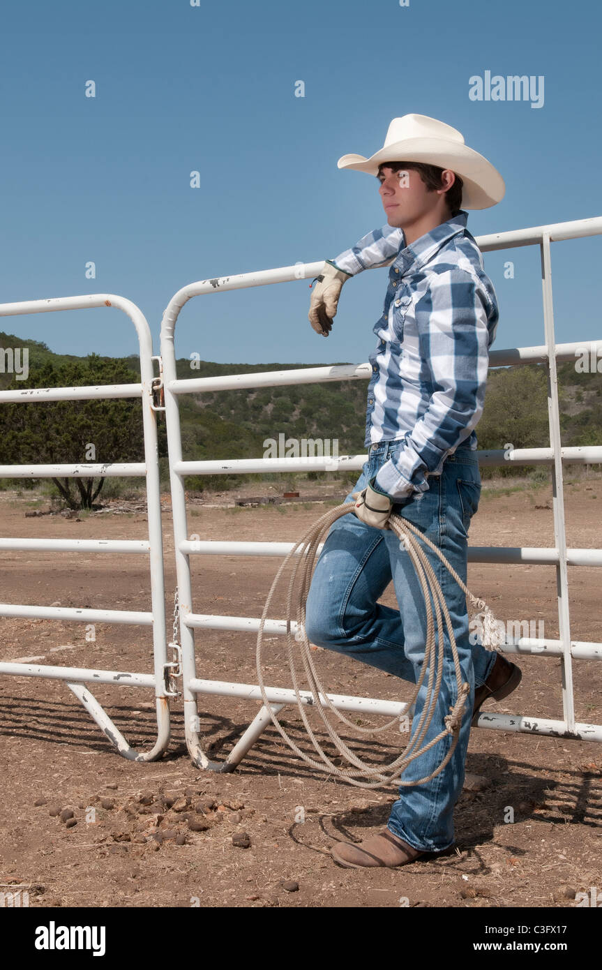 Young cowboy with rope on a ranch Stock Photo