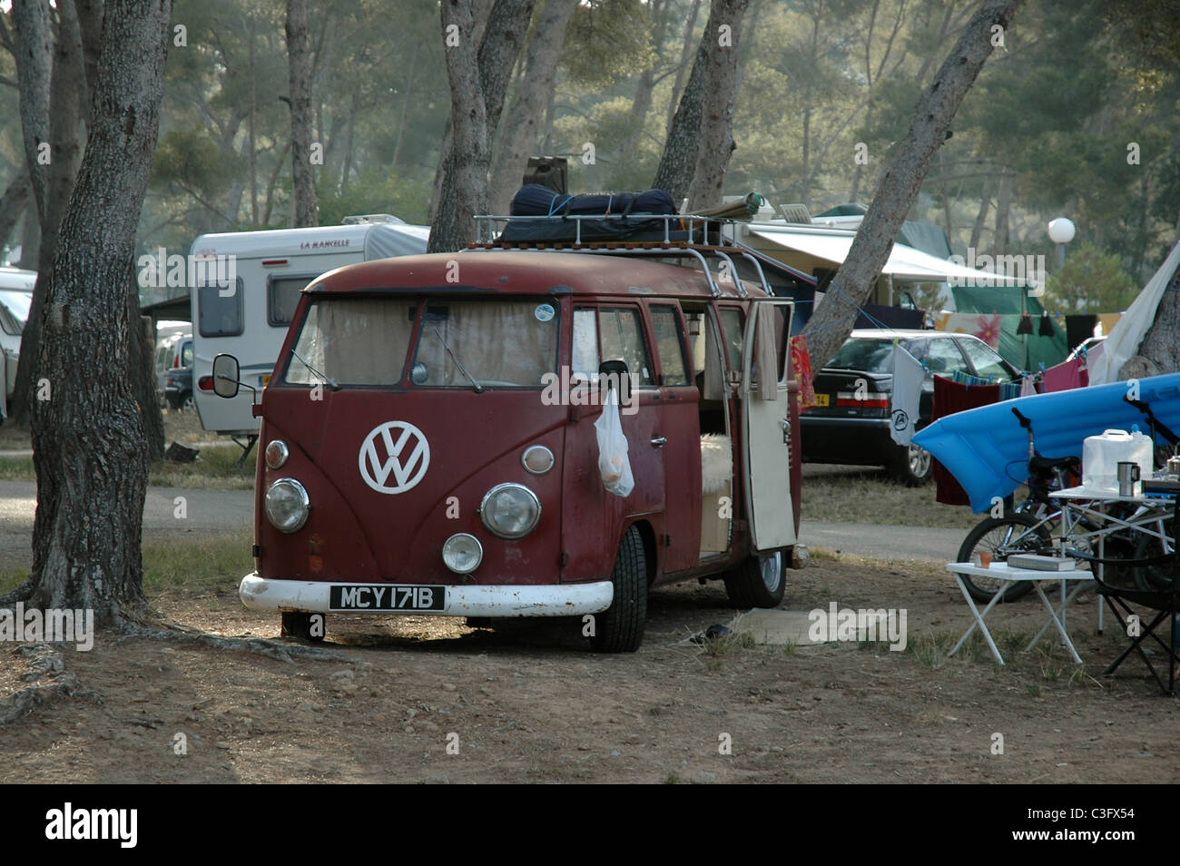 Battered old Volkswagen Split Screen camper van in campsite at Agay on the South Coast of France. Stock Photo