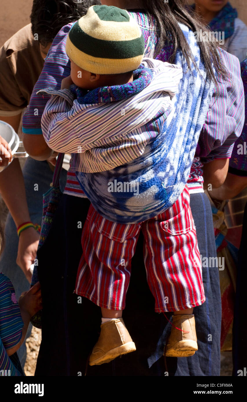Carrying a child, Todos Santos, Guatemala, Central America Stock Photo