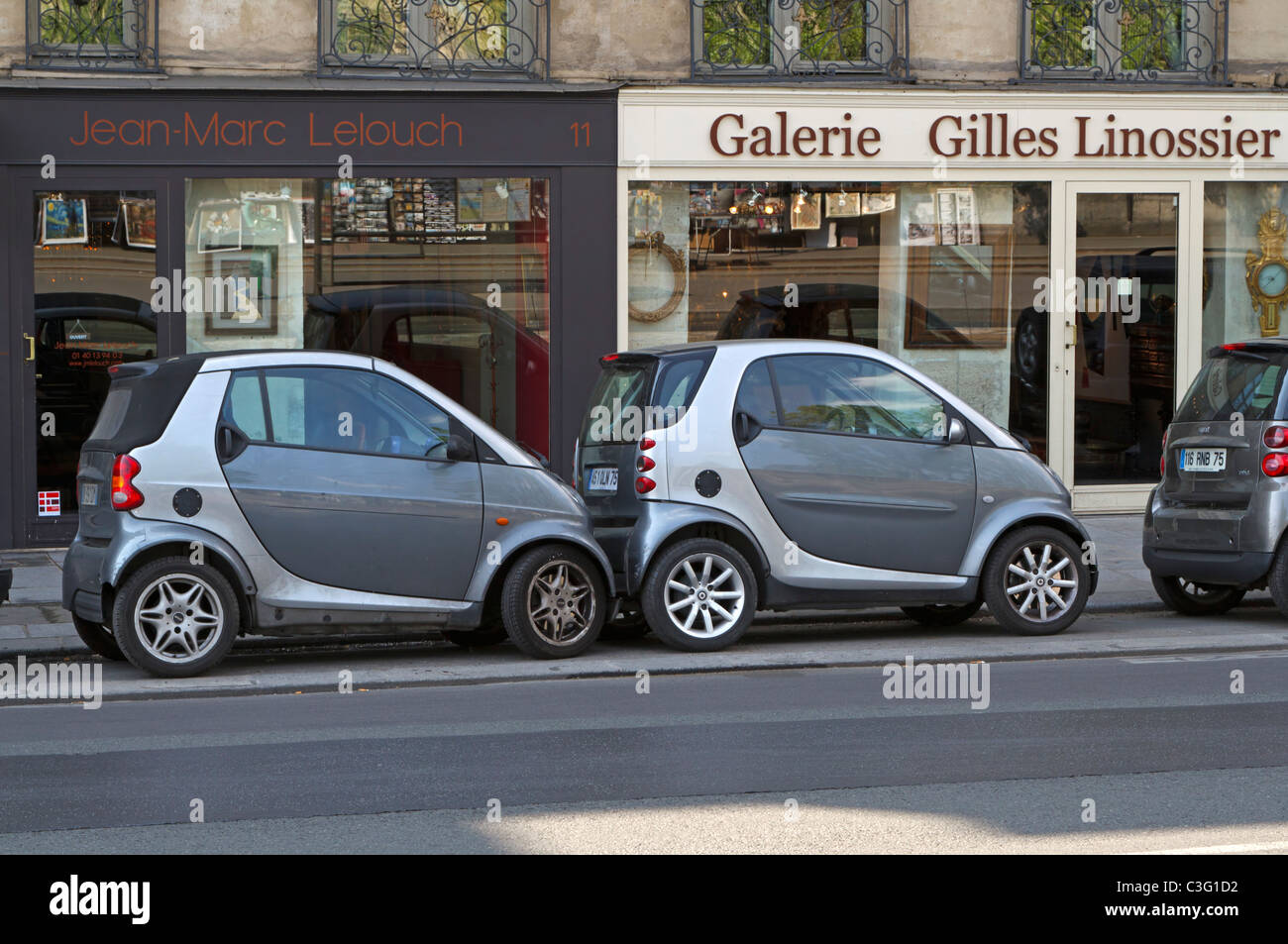 Parking in Paris. Smart cars are parked touching each other in tight