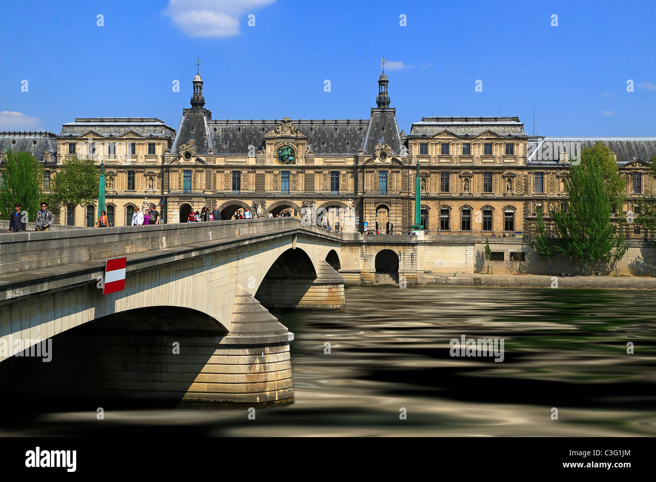 Pont du Carrousel, Seine River, and Musee du Louvre. Built in the 20th century to replace the original 19th century structure. Stock Photo