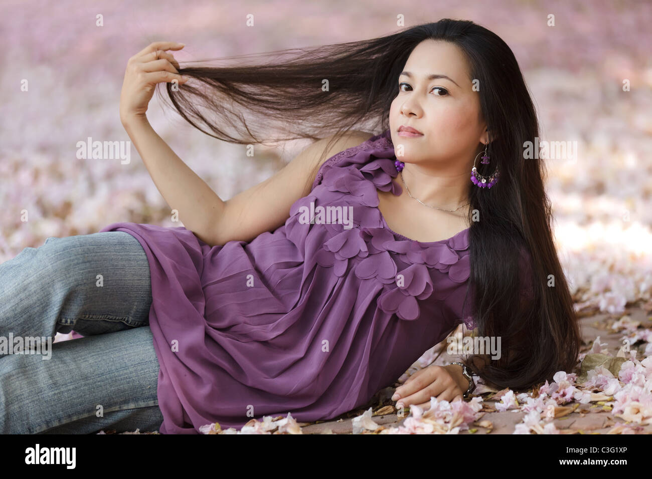 https://c8.alamy.com/comp/C3G1XP/beautiful-asian-thai-woman-lying-on-flowers-and-pulling-long-hair-C3G1XP.jpg