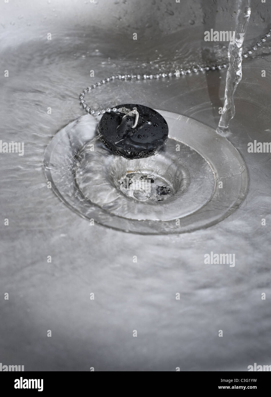 Water Running Down the Plughole in Kitchen Sink Stock Photo Alamy