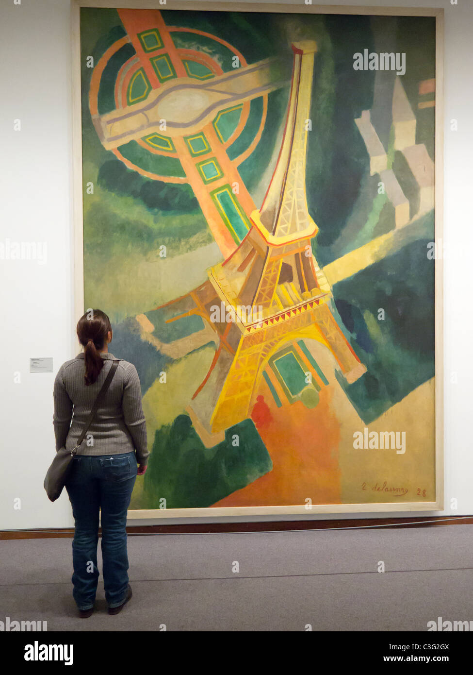 woman looking at painting The Eiffel Tower by Robert Delaunay in Neue Nationalgalerie in Kulturforum in Berlin Germany Stock Photo