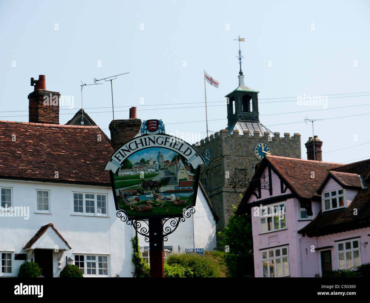 Village sign with St John the Baptist Church in the background in the Village of Finchingfield, Essex, UK Stock Photo