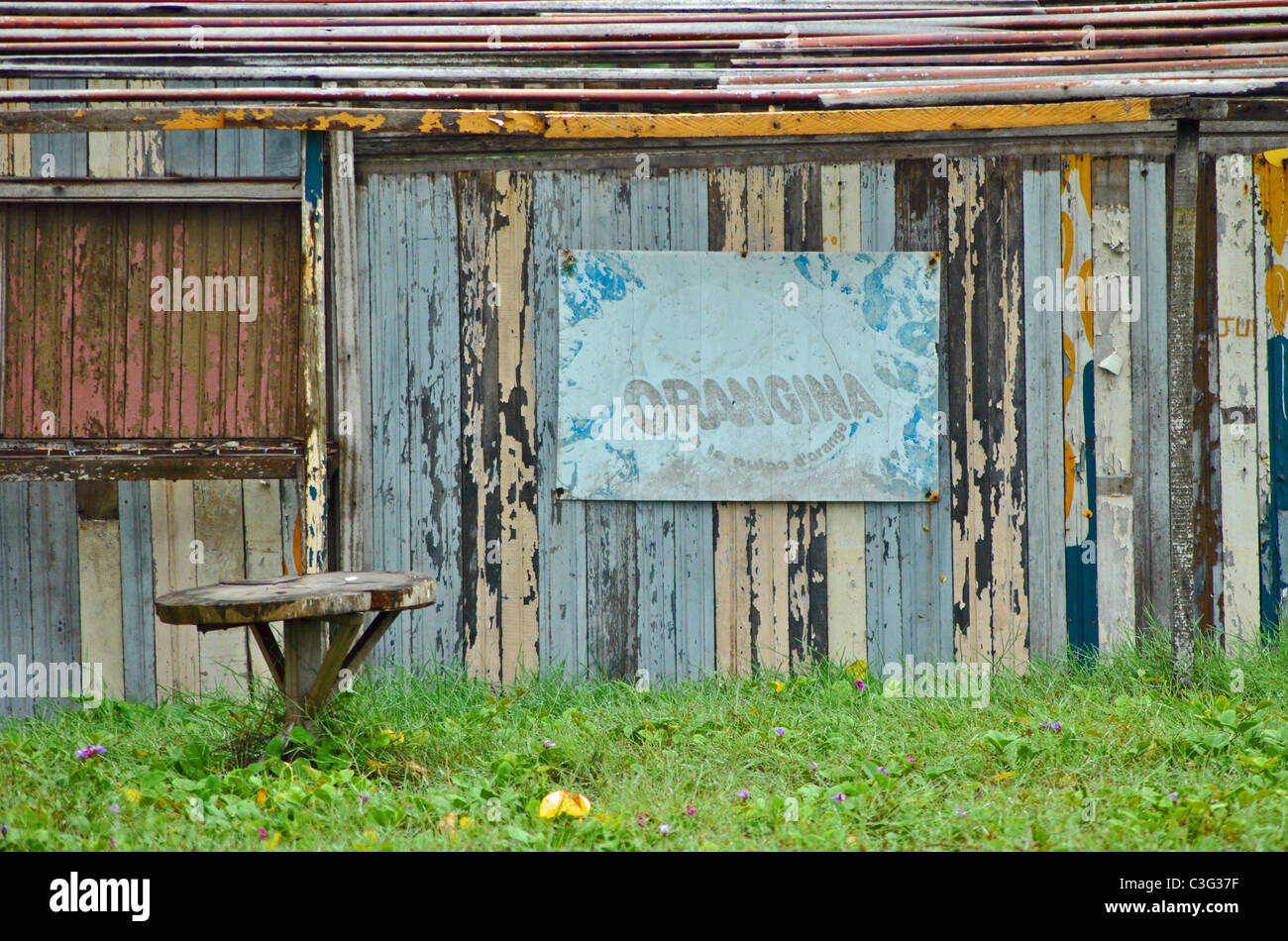 Derelict cafe with faded Orangina oster, Ivory Coast, West Africa Stock Photo