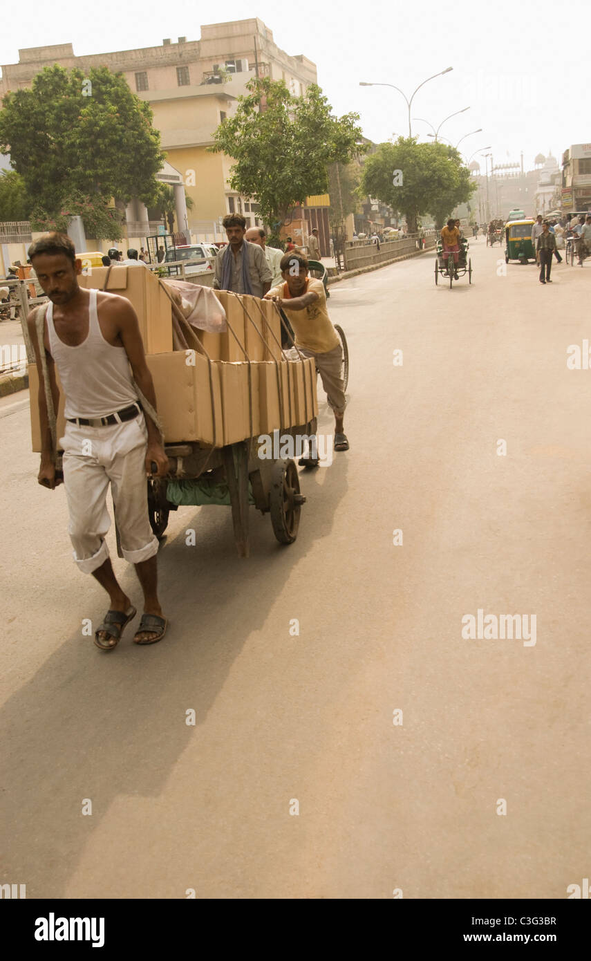Workers pulling a cart on the road, Chandni Chowk, Delhi, India Stock Photo