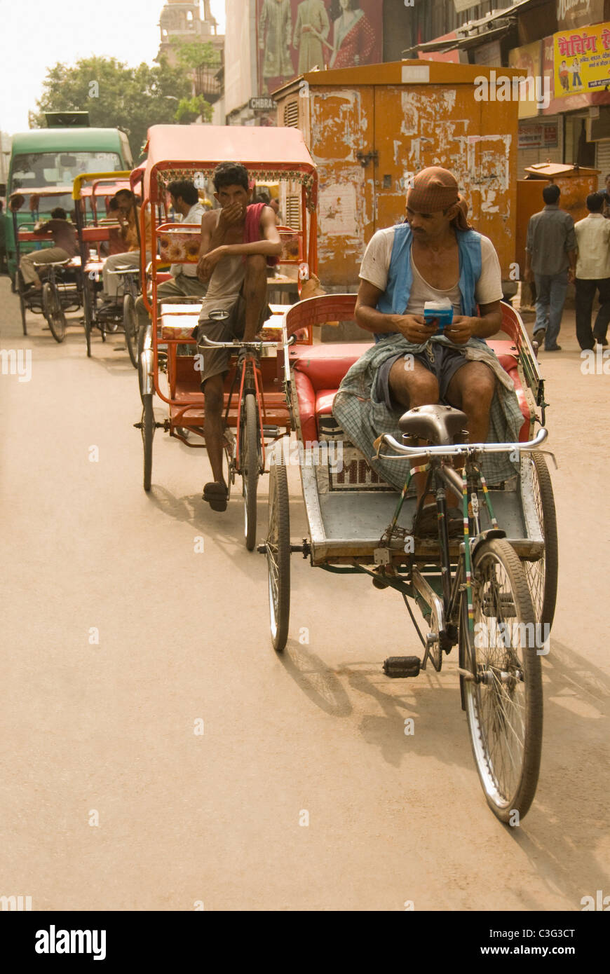 Rickshaw pullers on a street, Chandni Chowk, Delhi, India Stock Photo