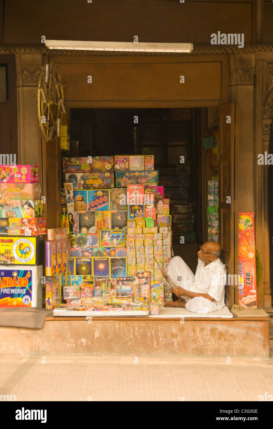 Vendor sitting in a fireworks store, Chandni Chowk, Delhi, India Stock Photo