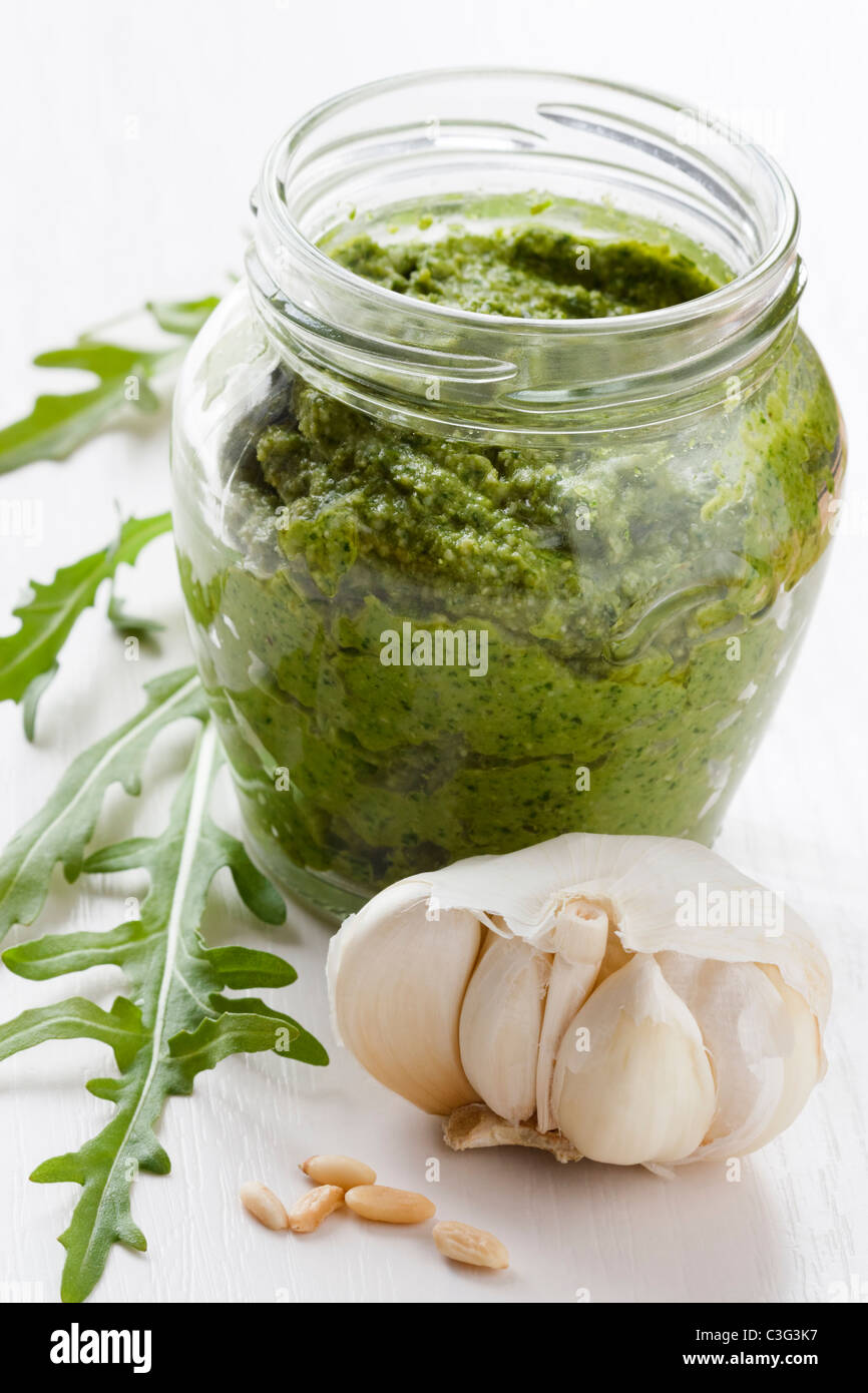A glass of fresh prepared rocket pesto with garlic and pine nuts. Stock Photo