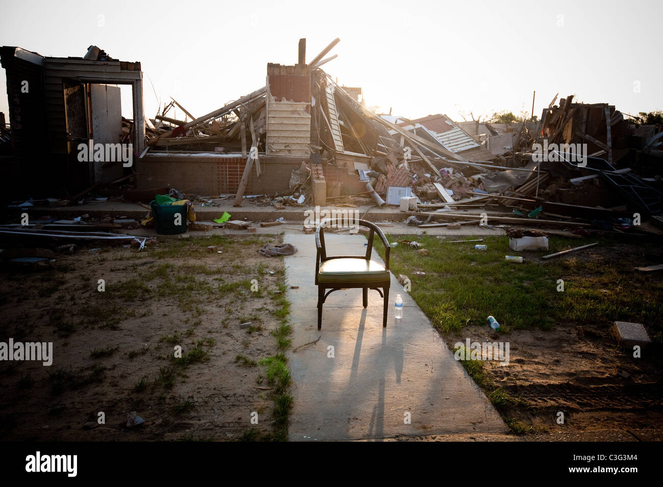 Tornado devastation in Tuscaloosa, Alabama.  Chair left behind in the rubble of destroyed homes. Stock Photo