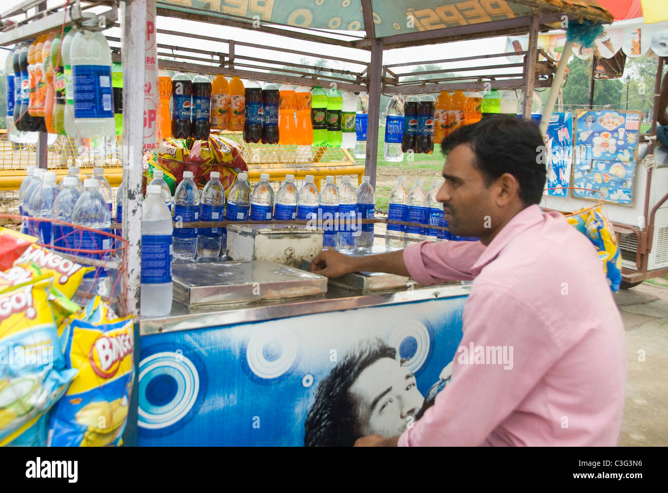 Vendor selling soft drinks at a market stall, New Delhi, India Stock
