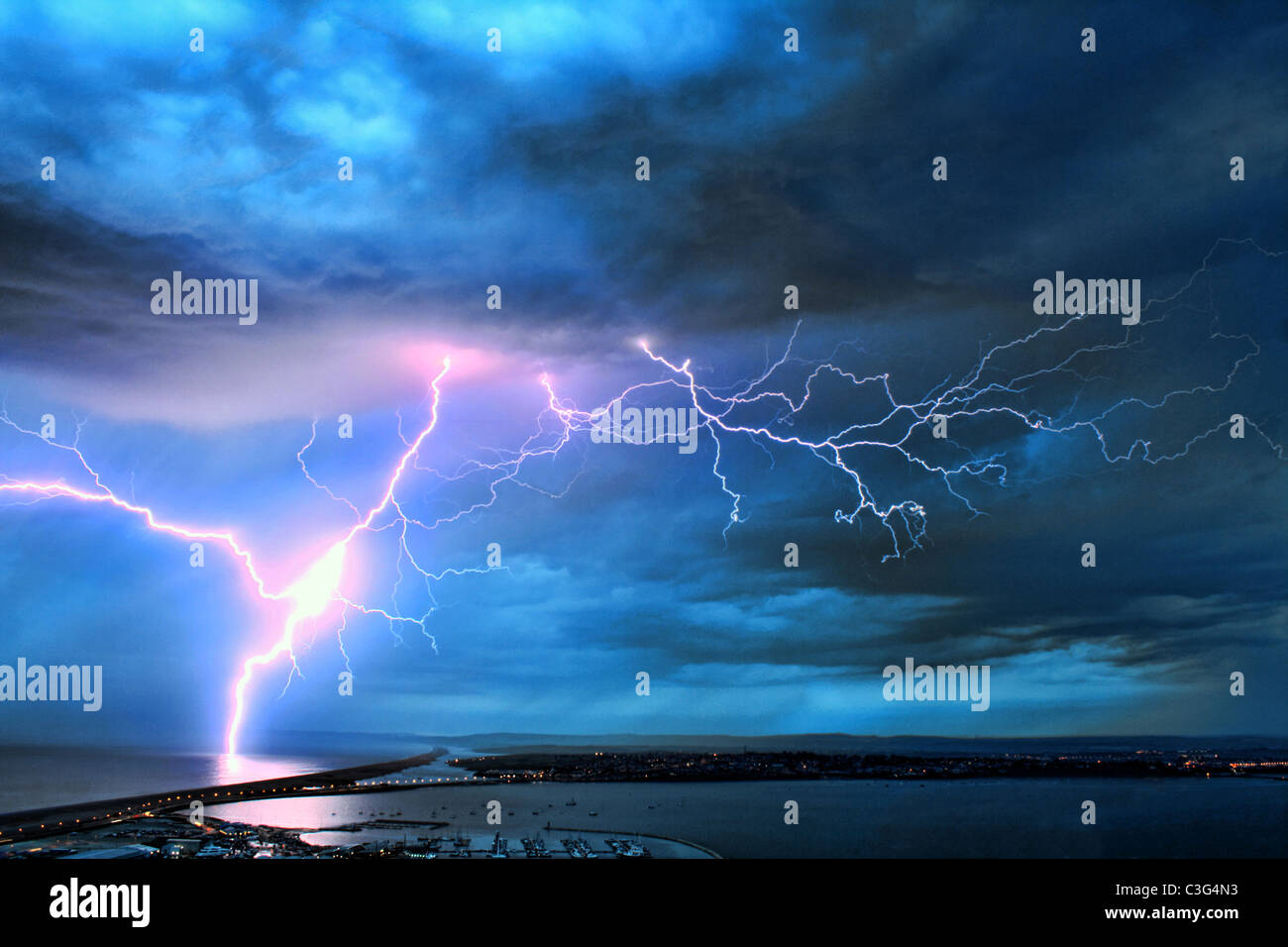 UK, Dorset, Stunning image of lightning over the Dorset coast during weekend storms after hot dry weather. Stock Photo