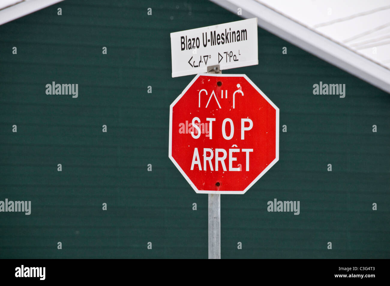 Stop sign in french, English and Cree languages in the Cree community of Mistissini Northern Quebec Canada Stock Photo