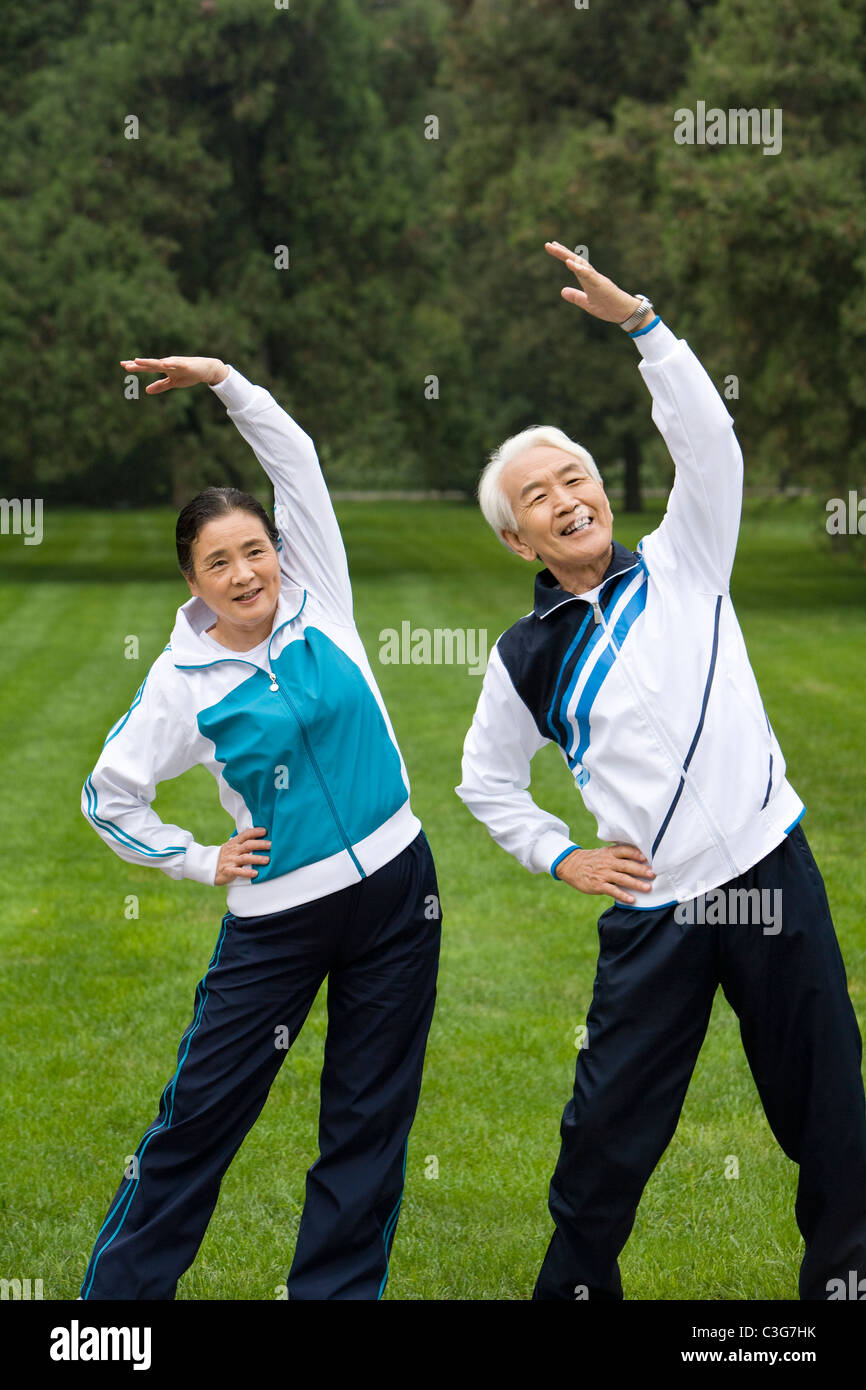 Senior Couple Stretching in a Park Stock Photo - Alamy