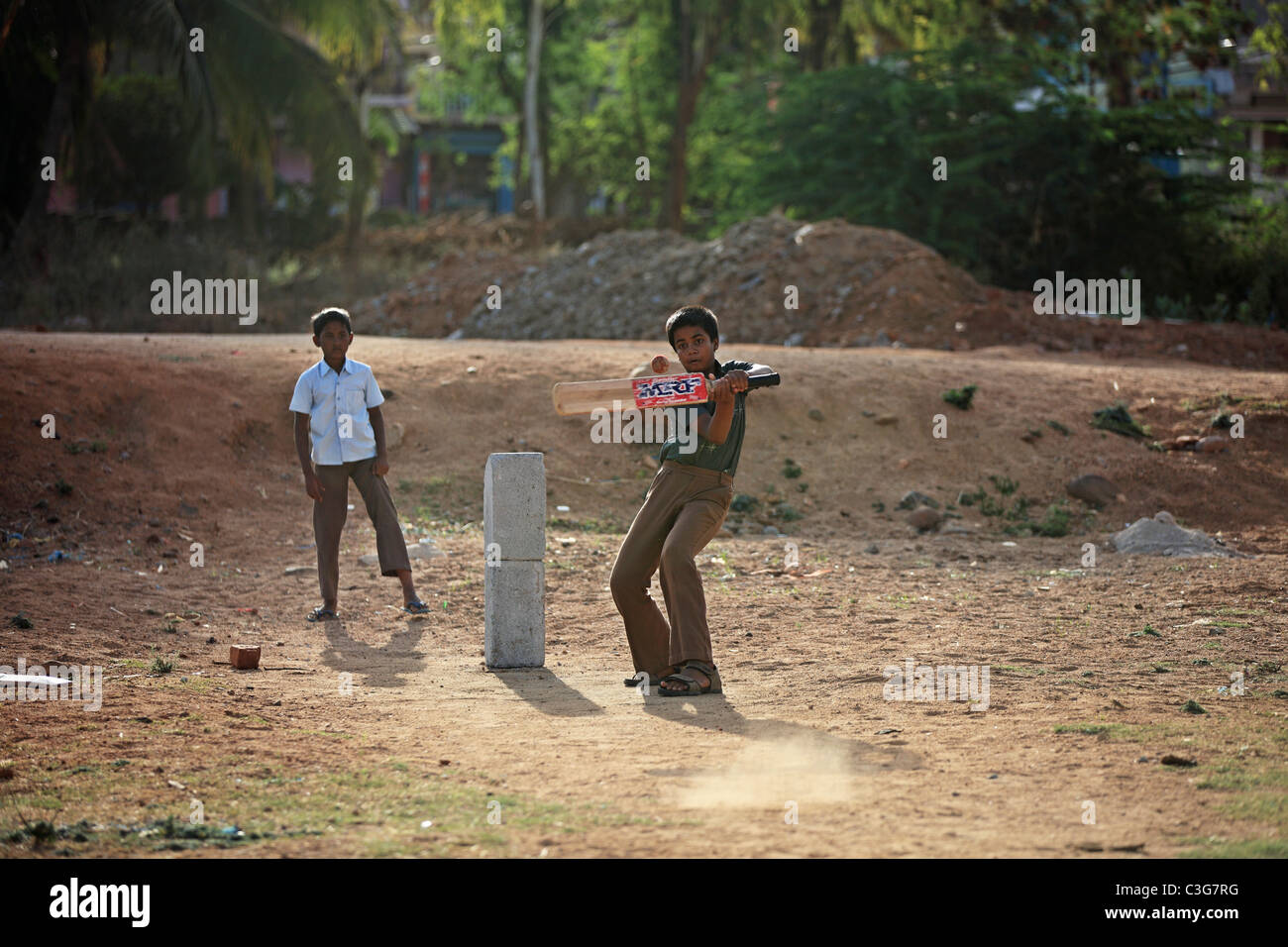 Boy play cricket in Andhra Pradesh South India Stock Photo