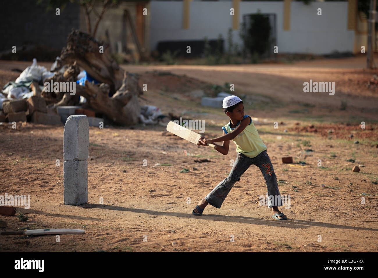 Boy play cricket in Andhra Pradesh South India Stock Photo
