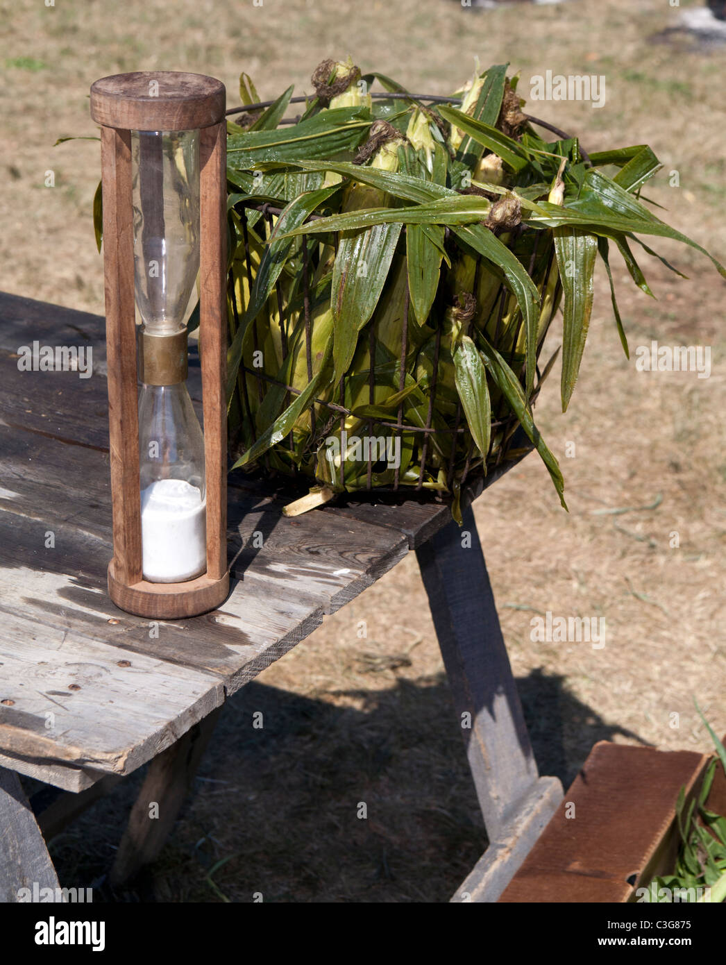Steamed corn in bushel basket with hourglass Stock Photo Alamy